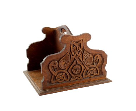 Alexander Ritchie (attributed), an Arts and Crafts Iona school carved oak book trough, bisected basket form, each ogee fret c