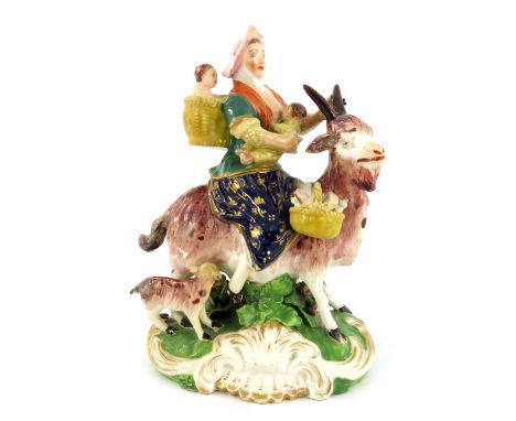 A Derby figure of the Tailor's Wife, circa 1770, modelled as a woman on a goat, with children, patch marks and incised N62, 1
