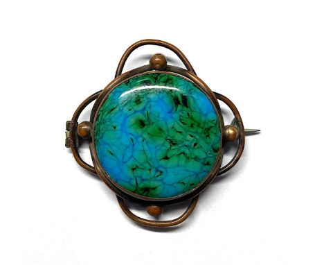 An Arts &amp; Crafts copper and enamel brooch, circa 1915, the circular panel enamelled in blue and green, within a knotted w