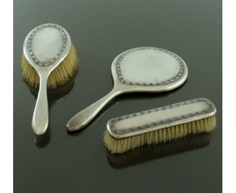Bernard Cuzner for Liberty and Co., an Arts and Crafts silver and enamelled dressing table mirror and brush set, Birmingham 1