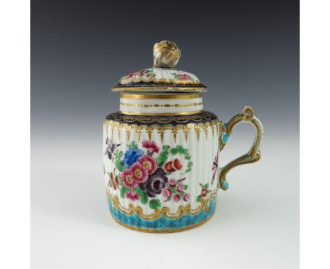 A Worcester polychrome mustard pot, 1770, crescent mark, cylinder drum form, reeded and painted with floral bouquets between 