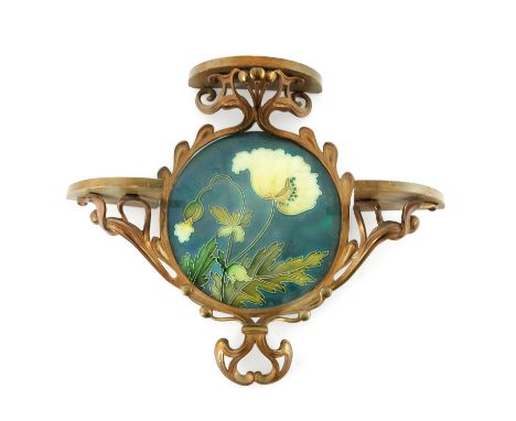 Carl Luber for Johann von Schwarz, an Art Nouveau tile set gilt metal wall shelf, the circular plaque with poppy on teal grou