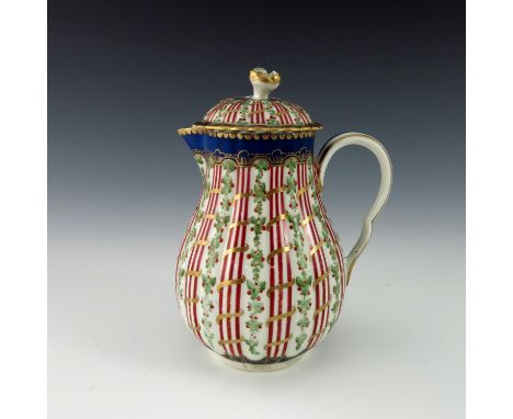 A Worcester jug and cover, circa 1775, painted with the Hop Trellis pattern, reeded baluster form, sparrow beak, highlighted 