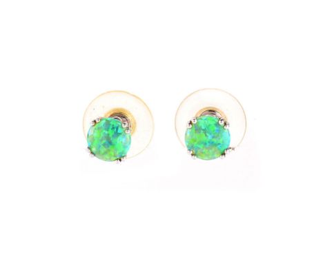 Vintage Black Opal and 14 Karat White Gold Stud Earrings. Opals measure 8mm diam. Stamped 14K. Very good condition. Approx. w