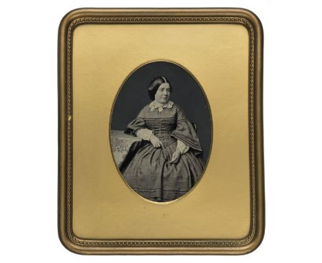 *Whole-plate ambrotype, 1850s,  of a seated lady, photographer unknown, 19.5 x 14cm, oval gilded wooden mat, good quality woo