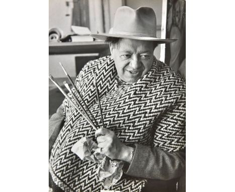 *McCombe (Leonard, born 1923). Diego Rivera, 1949,  vintage gelatin silver print of the artist holding paintbrushes, small cr