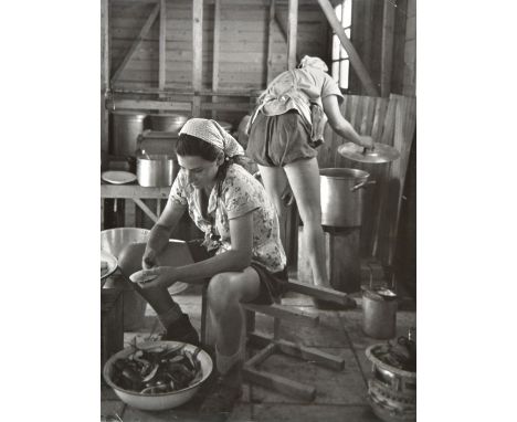 *Capa (Robert, 1913-1954). Israel's First Year, 1949,  vintage gelatin silver print, showing two women preparing food, corner