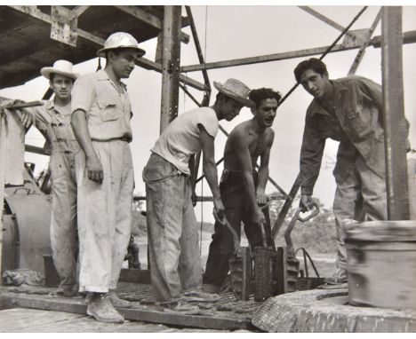 *Freund (Gisela, 1908-2000). Oil workers in Mexico, c. 1950, printed later,  gelatin silver print, 19.5 x 24cm, together with