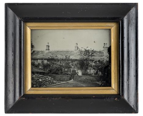 *Half-plate ambrotype of an unidentified stone cottage, c. 1860,  10 x 13.5cm, wooden frame with gilt surround, overall 19 x 