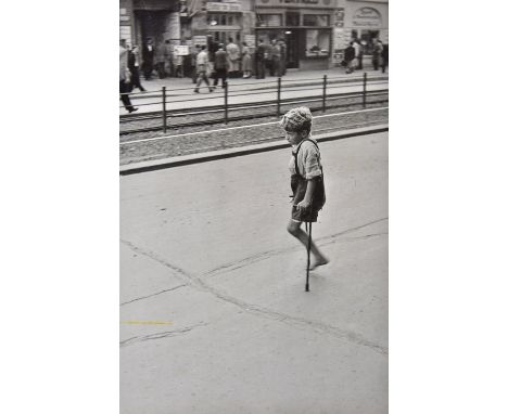 *Cartier-Bresson (Henri, 1908-2004). A one-legged boy on crutches in Berlin, 1951,  vintage gelatin silver print, short split