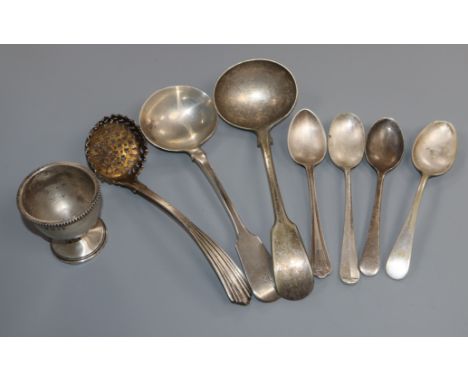 A George IV silver sifter spoon, a William IV silver sauce ladle, a silver egg cup and five plated spoons.