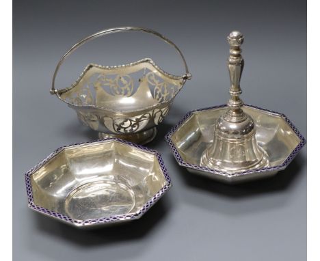 A silver hand bell, a silver bonbon basket and a pair of George V silver and enamel octagonal bowls.