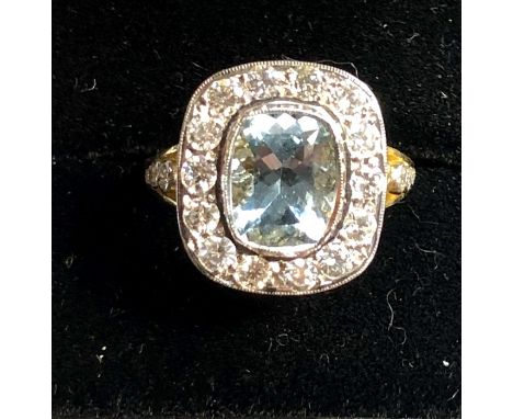 18ct Gold Diamond and Aquamarine ring hallmarked 18ct set with large Aquamarine that measures approx 9.5mm by 7.5mm and 14 di