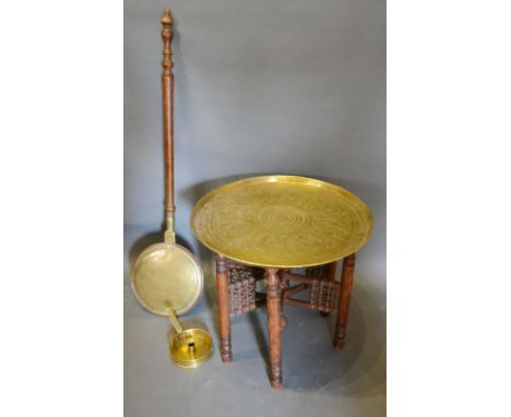 A Benares Brass Tray on Folding Wooden Stand, together with a brass chamber stick and a brass warming pan with turned wooden 