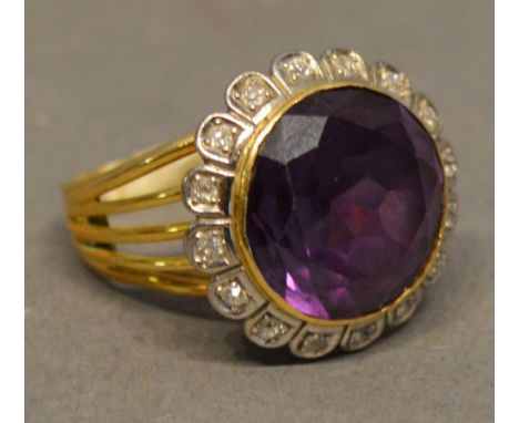 An 18 Carat Yellow Gold Large Amethyst and Diamond Cluster Ring set with large circular amethyst surrounded by diamonds withi