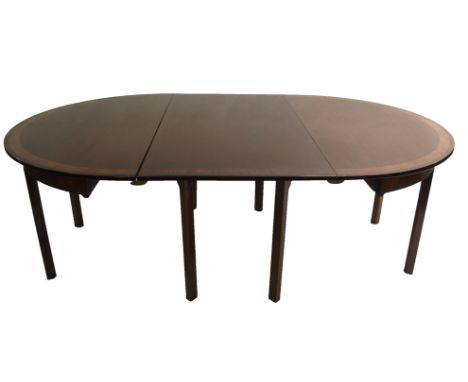 A Georgian style mahogany, crossbanded and ebony lined twin D-end dining table with gate-leg action, with two broad leaves an