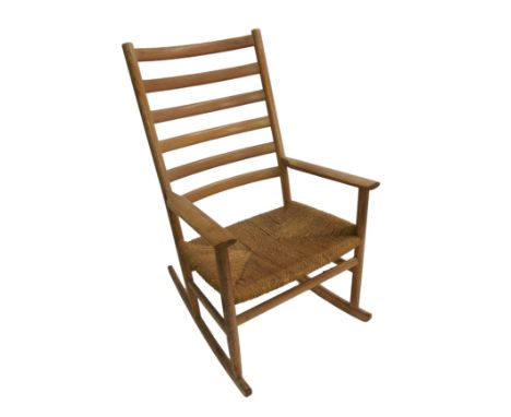 A Danish ash ladder-back rocking chair with rush seat, label to base, 105cm tall