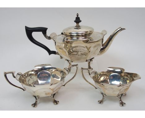 A three piece silver tea service by Walker & Hall, Sheffield 1913, of tapering circular form with lugged border and faceted b