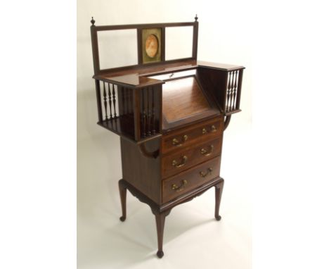An Edwardian mahogany and satinwood inlaid ladies writing desk with oval portrait panel above hinged skiver enclosing pigeon 