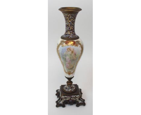 A Continental porcelain urn with chapleve enamel base and neck, the lustre glazed body of the vase with a gilded cartouche wi