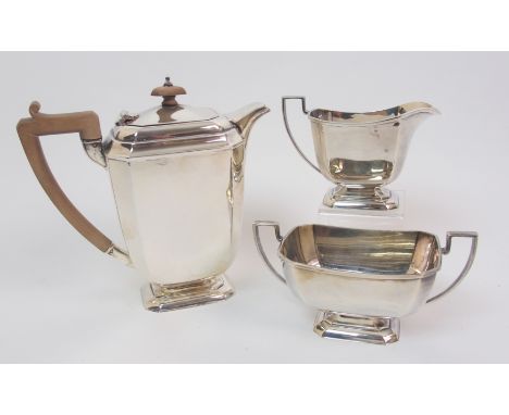 An Art Deco silver three piece tea service by Henry Clifford Davies, Birmingham 1933, the teapot with wooden finial and handl