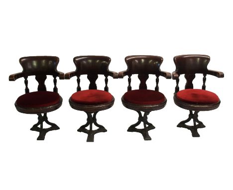 Eight Victorian mahogany ships revolving armchairs with carved vase shaped splats above drop-in seats and on cast iron tripod