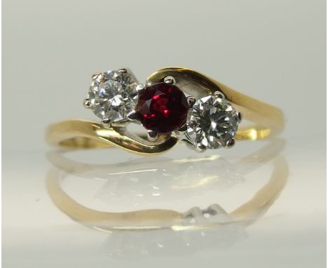 An 18ct gold garnet and diamond three stone ring in a twist design, diamonds estimated approx 0.40cts combined. Finger size S