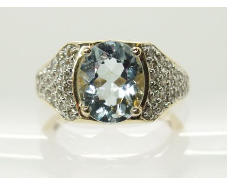 A 9ct gold aquamarine and diamond ring the oval facet cut aquamarine is approx 10mm x 8mm x 5mm, with pave diamond set should