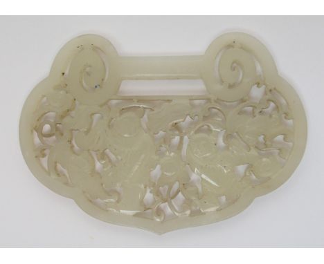 A Chinese jade belt buckle pierced with two figures amongst flowering branches and flying bats, 8.5cm wide