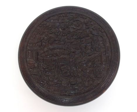 A Chinese export tortoiseshell circular snuff box carved all over with figures in gardens and pagodas, with initialled medall
