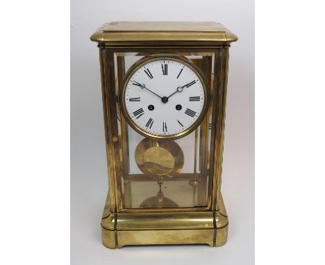 A late 19th century French brass cased four glass mantel clock the white enamel dial with black Roman numerals, the movement 
