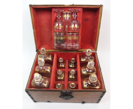 A Georgian oak decanter box with red fitted suede interior holding six large decanters, six small decanters with a lift out t