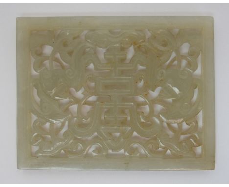 A Chinese jade rectangular plaque pierced with two birds and shou character amongst scrolling foliage, 7 x 5.5cm wide