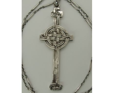 A silver Alexander Ritchie cross of interlaced ribbon design, the reverse of the cross is stamped with AR spectacle marks wit