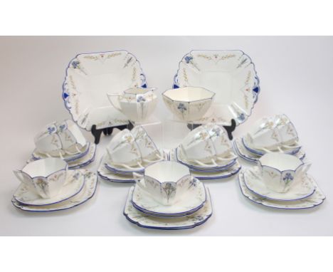 A Shelley Blue Iris pattern tea set in the Queen Anne shape comprising two cake plates, eleven cups, twelve saucers, twelve p