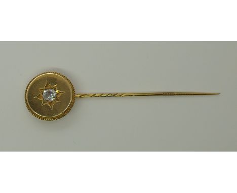 A large yellow metal stick pin set with an old cut diamond old cut diamond estimated approx 0.60cts in star setting to rope w