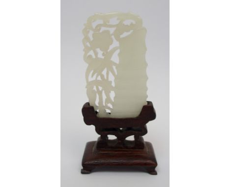 A Chinese jade carving pierced with bamboo and flowering foliage, 6cm high, wood stand