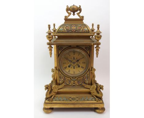 A French gilt metal mantle clock the front, top and sides with enamel decoration, the dial with roman numerals, flanked eithe