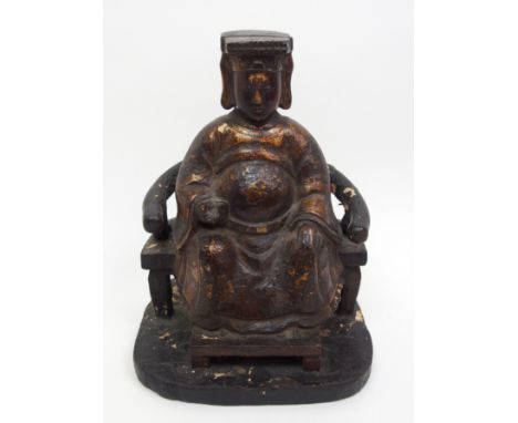 A Chinese gilt and lacquered figure of an official seated on a yolk back armchair and feet resting on a stool, 22.5cm high