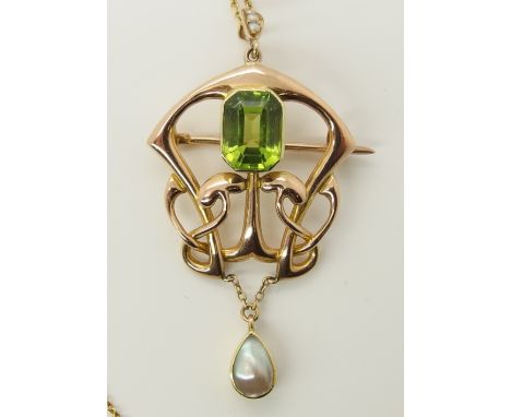 A 15ct rose gold Art Nouveau pendant set with a peridot and a blister pearl the peridot is emerald cut and approximately 10mm