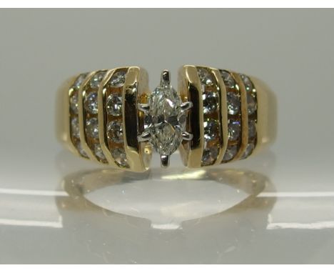 A 14ct gold marquis and brilliant cut diamond ring the marquis diamond is estimated approx 0.27cts with the further brilliant