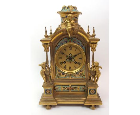 A French gilt metal mantle clock with painted enamel decoration to front, sides and top, the dial with Roman numerals, flanke