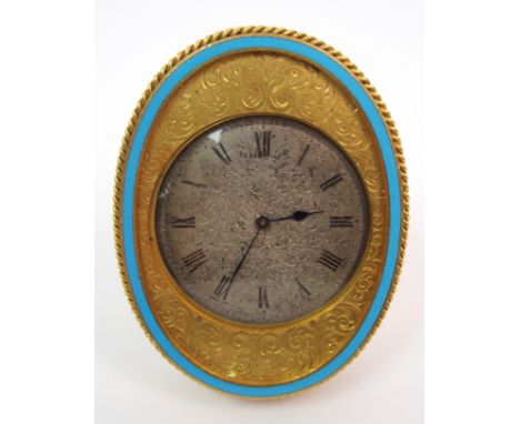 A gilded metal oval strut clock the silvered dial with chased scrolling acanthus decoration and painted roman numerals, with 