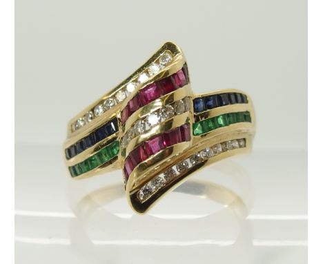 An 18ct diamond, ruby sapphire and emerald dress ring channel set in rows, finger size O, weight 6.2gms