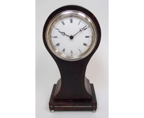 An Edwardian tortoiseshell mantle clock of balloon shape with silver plated mounts and inlay, upon four bun feet, 23 cm high