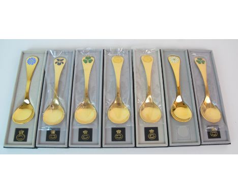 Thirteen Georg Jensen silver gilt and enamel year spoons, 1976-1981 three similar year knives, four similar year forks, all i