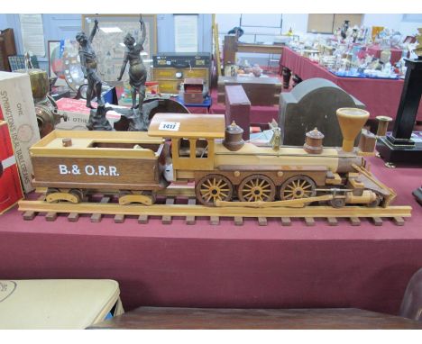 A Wooden Model of a Steam Engine, on a track with a log carrier.