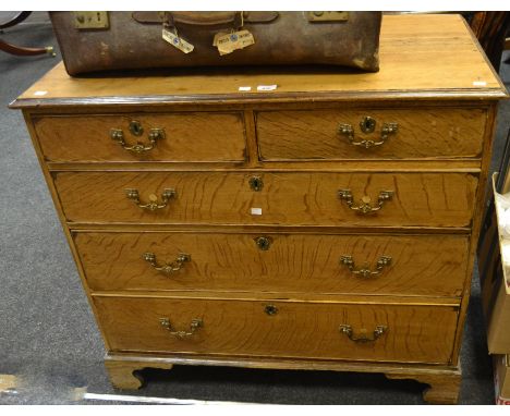 A George III chest of two short above three long cockbeaded drawers, bracket feet