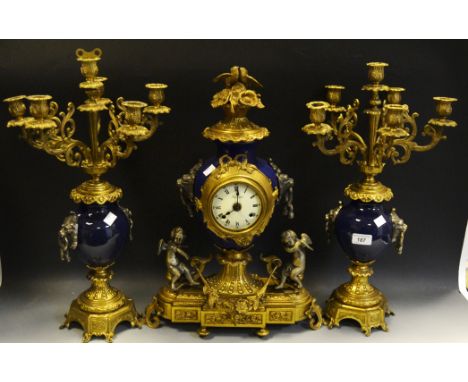 An Italian gilt metal mounted and blue ceramic  clock garniture, the white enamelled dial with Roman numerals, twin winding h