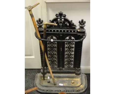 A Coalbrookdale style cast iron stick stand; a horn handled walking stick, another 